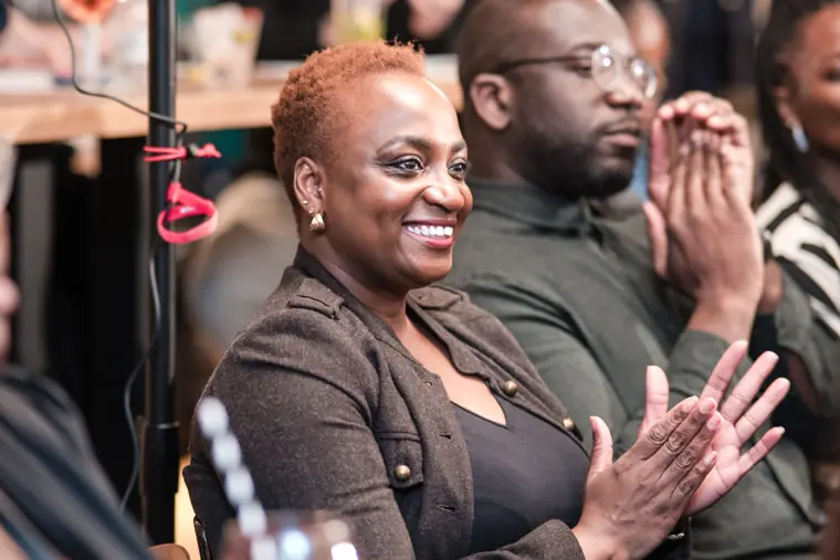 An audience member applauds a presentation.