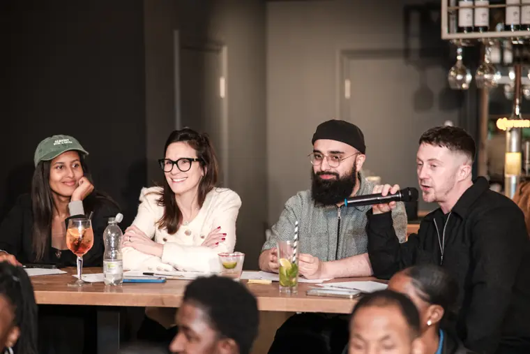 The judging panel listens to a founder.