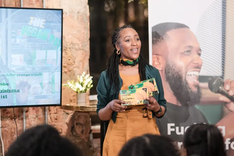 A founder presents her product on stage.