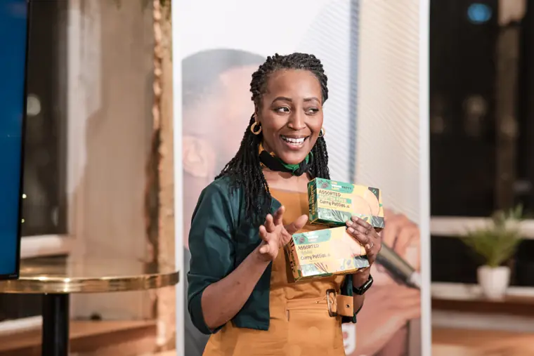A founder shows a product to the room.
