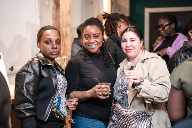 Three attendees share a group portrait.