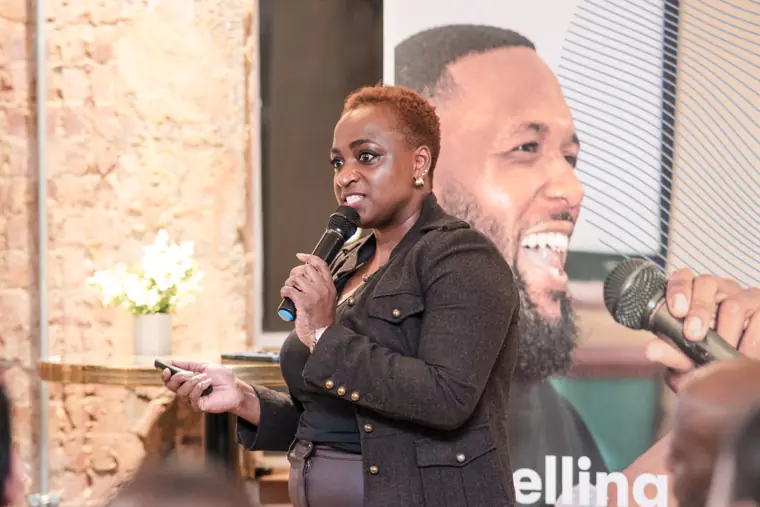 A founder addresses guests at the mixer.