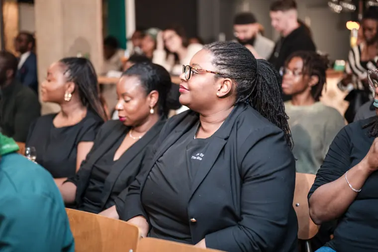 Guests applaud a founder presentation.
