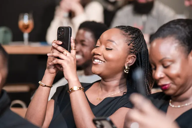 An attendee photographs a moment on stage.