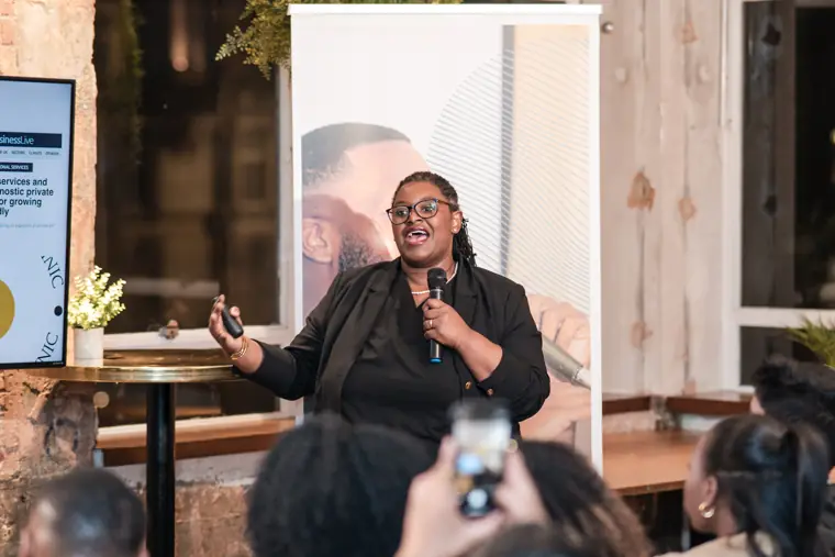 A founder shares her venture with the audience.