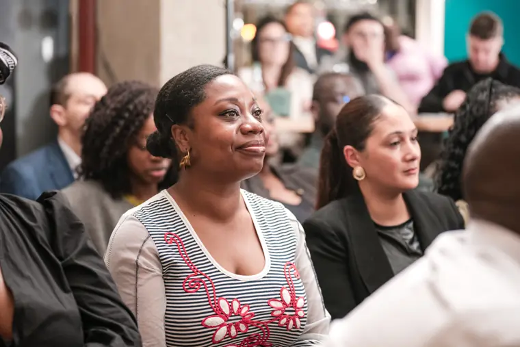 Guests follow the pitches from the front rows.