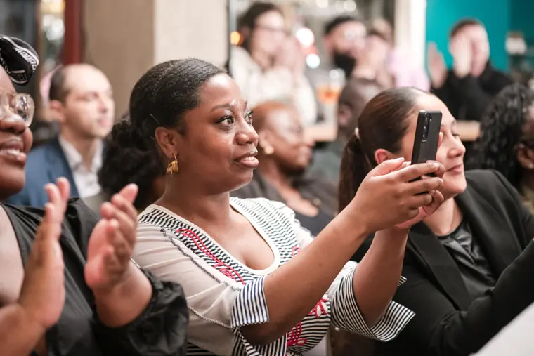 A guest photographs the event on her phone.