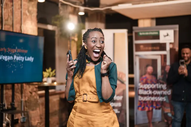 A founder celebrates on stage.