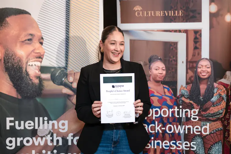 A founder poses with her certificate.