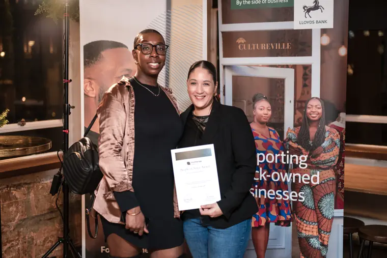 A founder receives an award certificate.