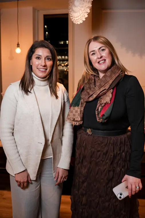 Two guests pose together after the event.
