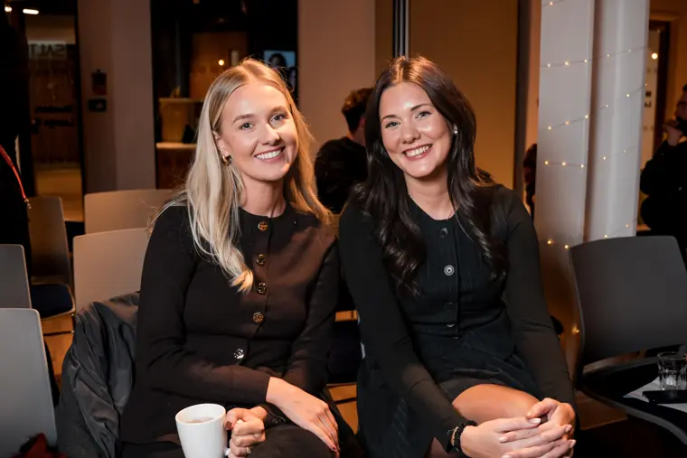 Two guests smile for a portrait.