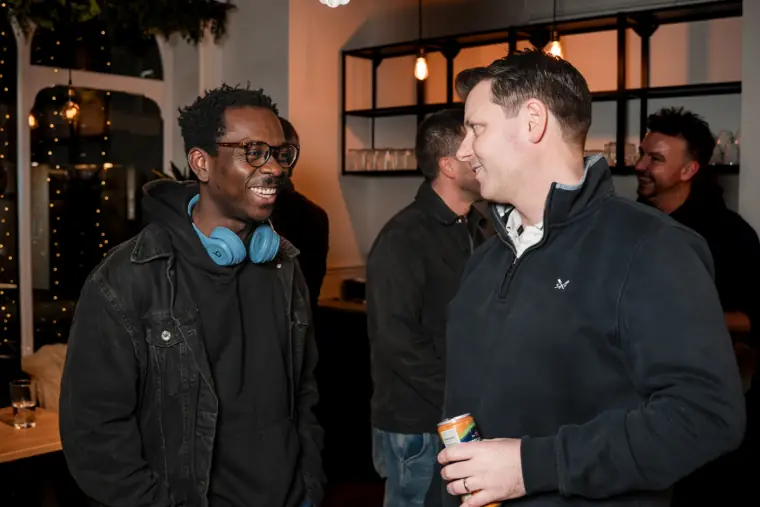 Two guests connect over a drink.