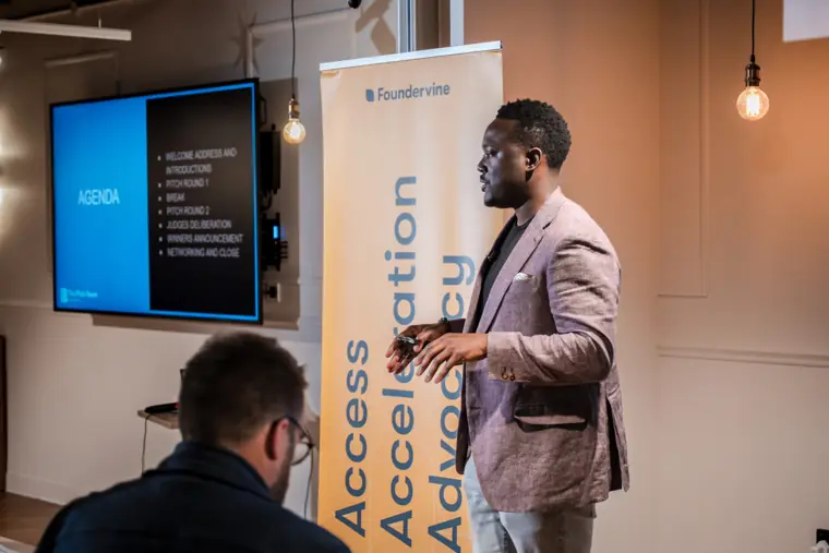 A speaker addresses founders and investors.