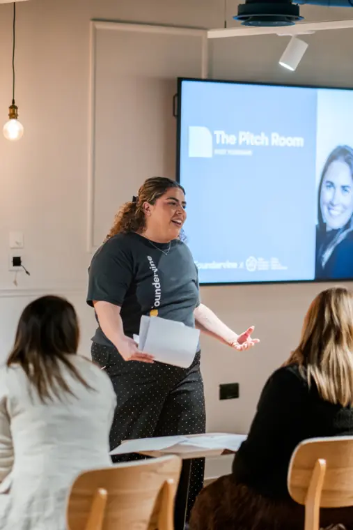 A presenter joins a founder on stage.