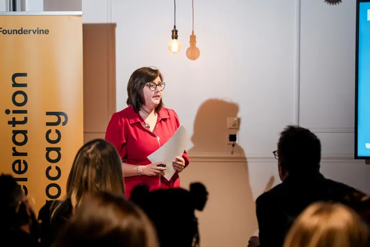 A speaker introduces the Pitch Room programme.