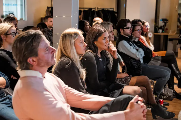 Guests listen to the pitch presentations.