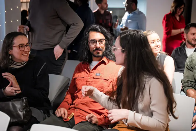 Guests discuss ideas at the reception.