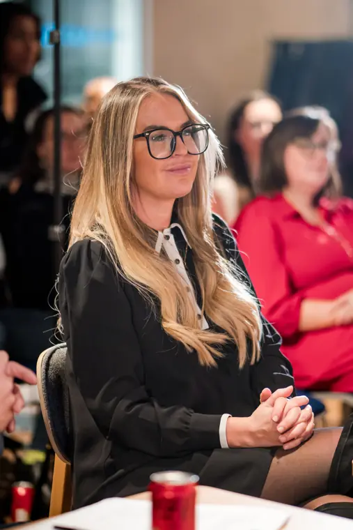 An audience member listens to the pitches.