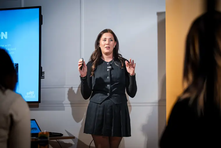 A founder presents her venture to the room.