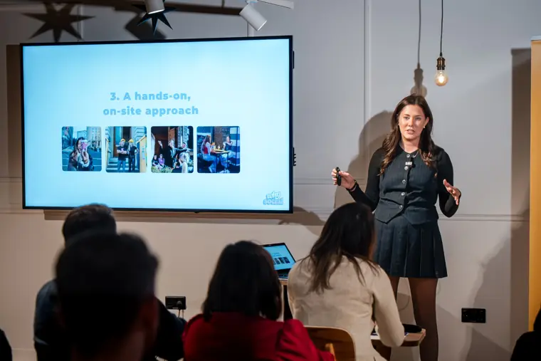 The audience follows a founder pitch.