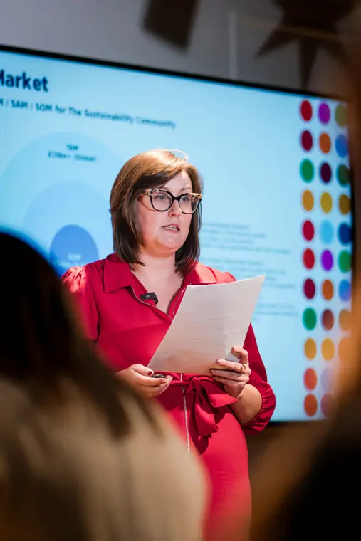 A host addresses the Pitch Room audience.