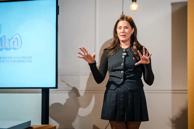 A founder explains her venture on stage.