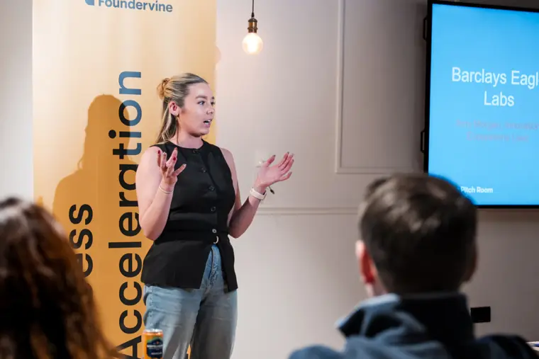 A founder answers a question during her pitch.