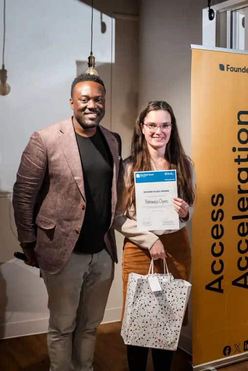 A founder poses with his recognition certificate.