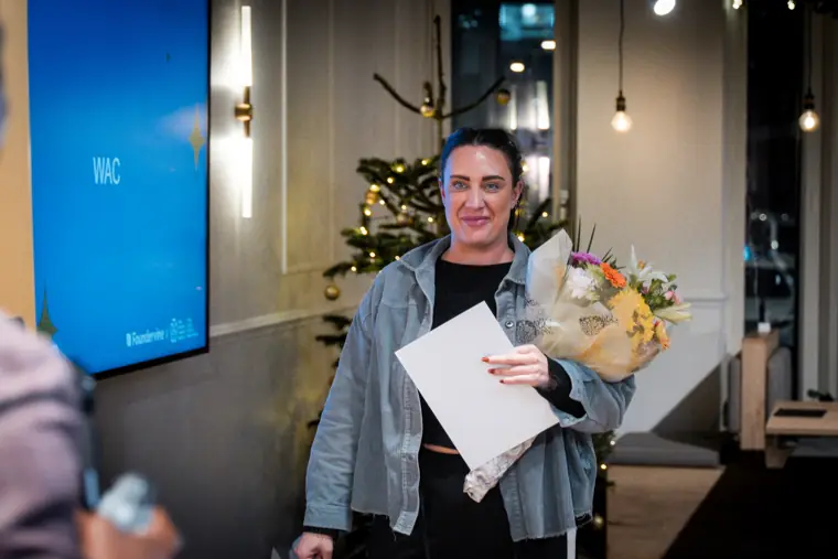 An award recipient smiles for a portrait.
