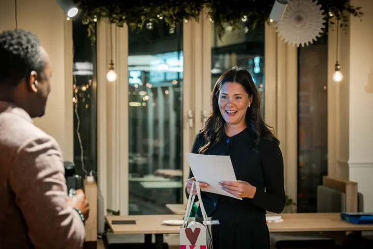 A founder speaks with a guest at the venue.