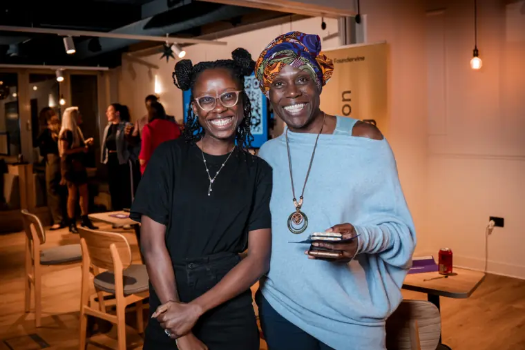 Two attendees pose together at the reception.