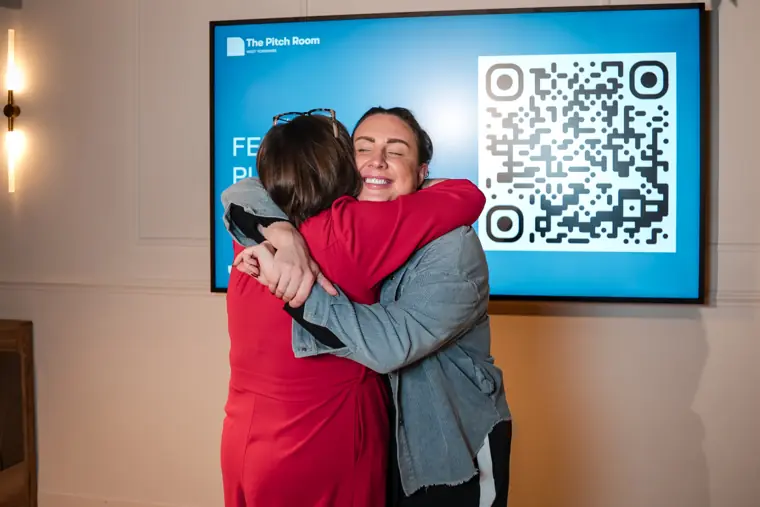 A founder celebrates with a hug.