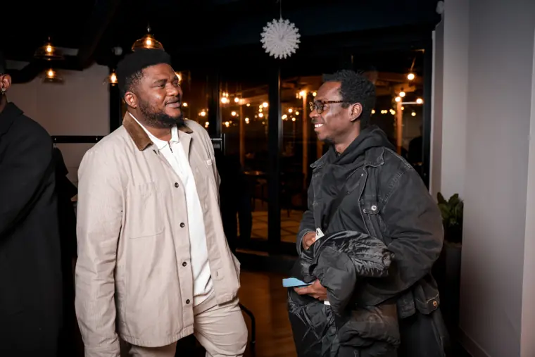 Two guests talk at the reception.