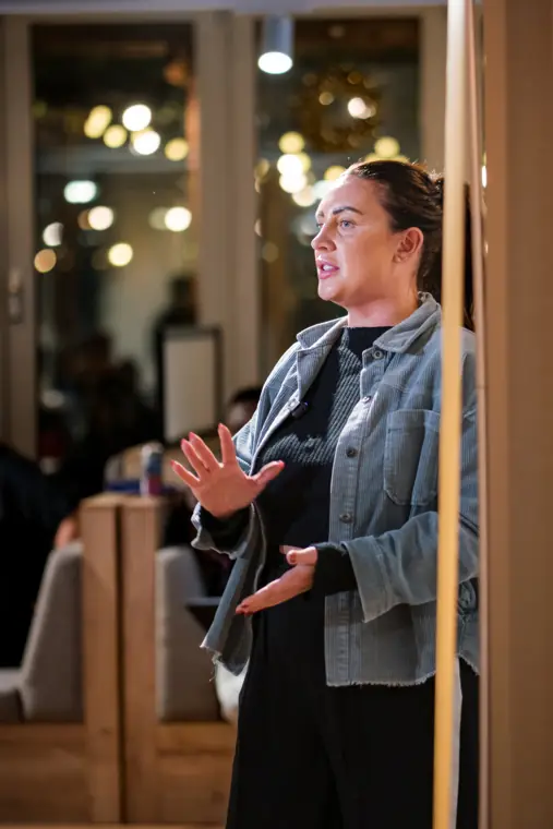 A guest speaks beside the event space.