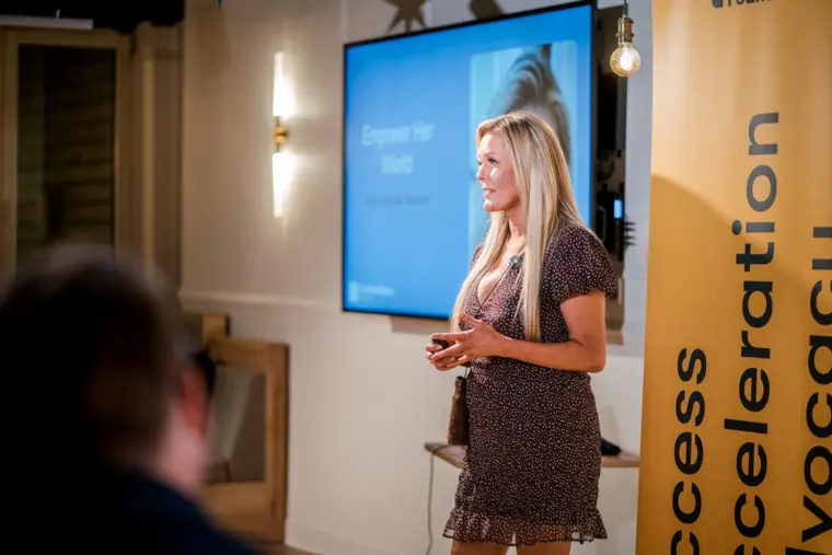 A founder explains her business on stage.