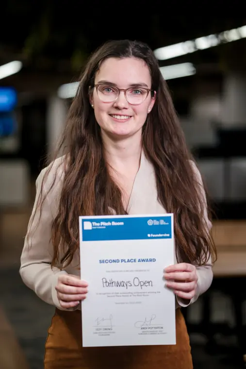 A founder holds her Pitch Room certificate.
