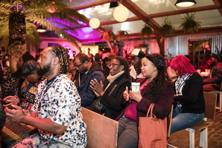 Attendees watch the programme together.