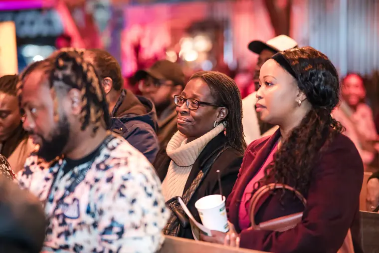 Guests react to the stage discussion.