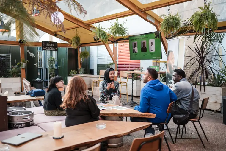 Attendees connect in the venue courtyard.
