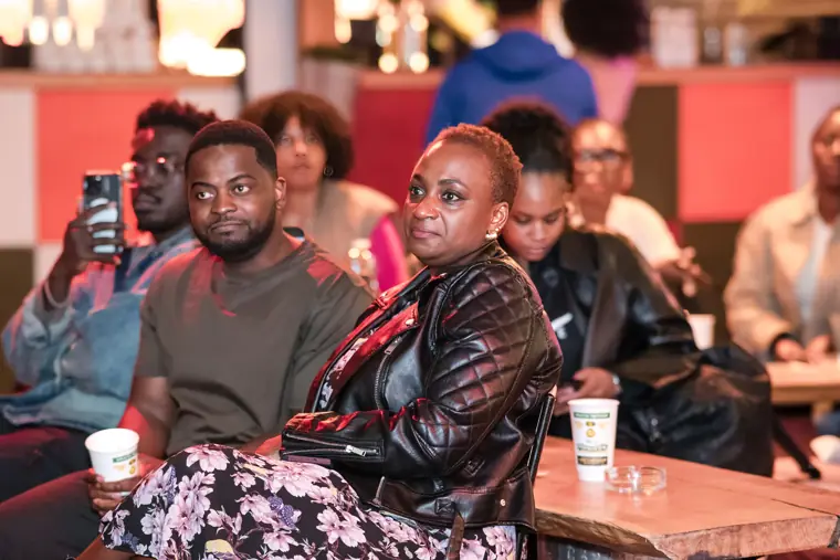 Guests follow a conversation during the mixer programme.