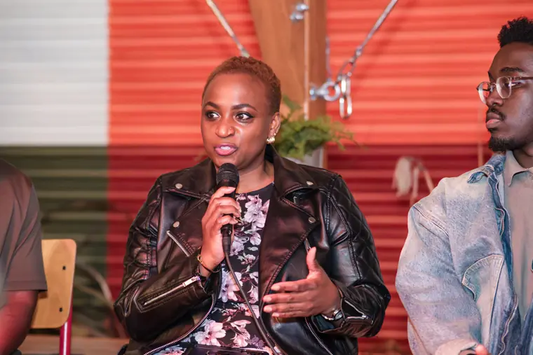 A speaker shares her experience on stage.