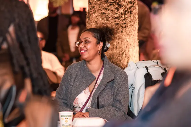 An attendee listens during the programme.