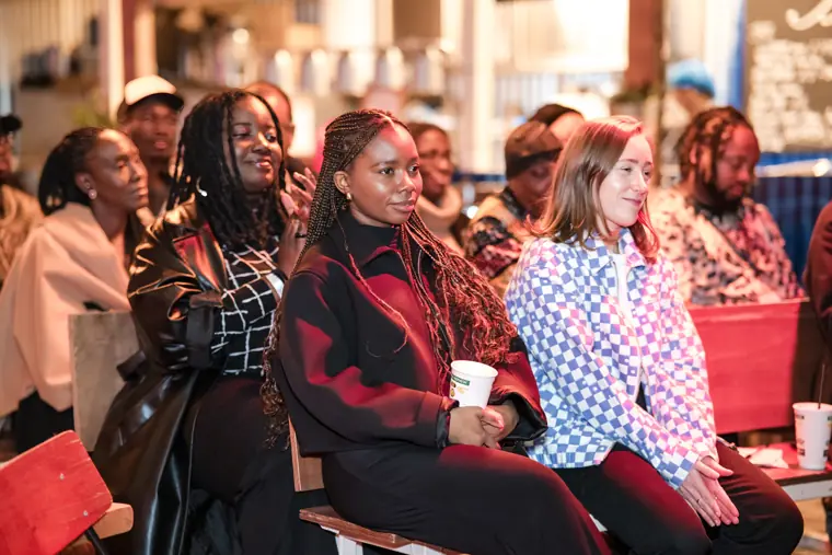 Guests listen from the front rows.