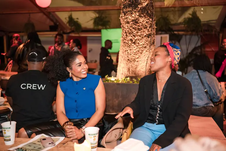 Two guests catch up at the event.