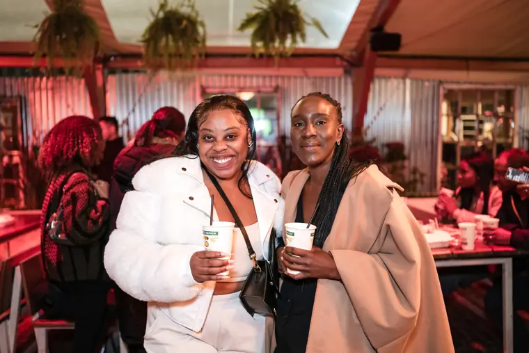 Two guests enjoy a conversation inside the venue.