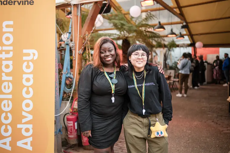 Two guests pose at the Foundervine banner.