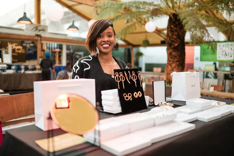 A founder presents her products at a stand.
