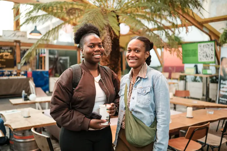 Two attendees catch up near the courtyard.