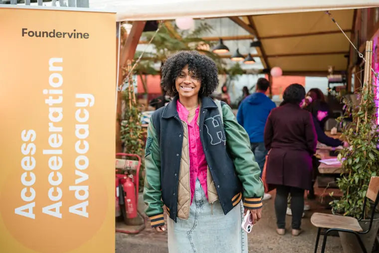 A founder welcomes guests to her stand.